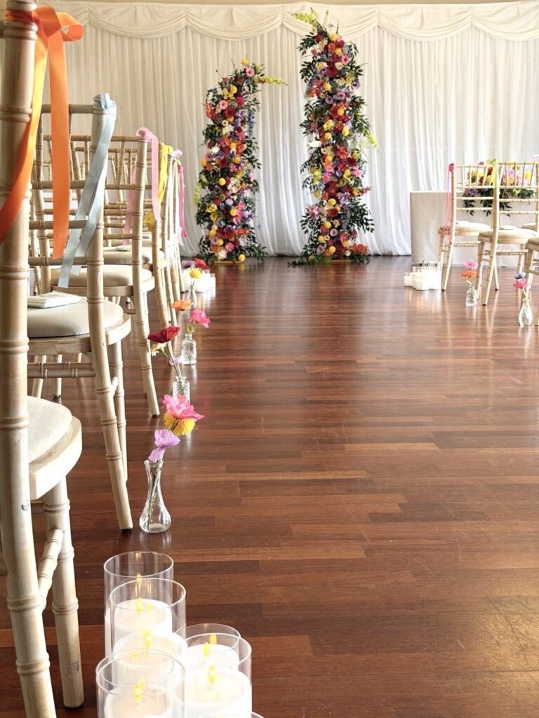 Ceremony aisle with floral arch at Welwyn Garden City